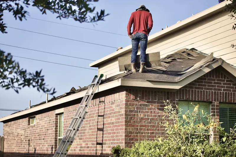 Professional roofer working on a residential roof in North Central Taylorsville